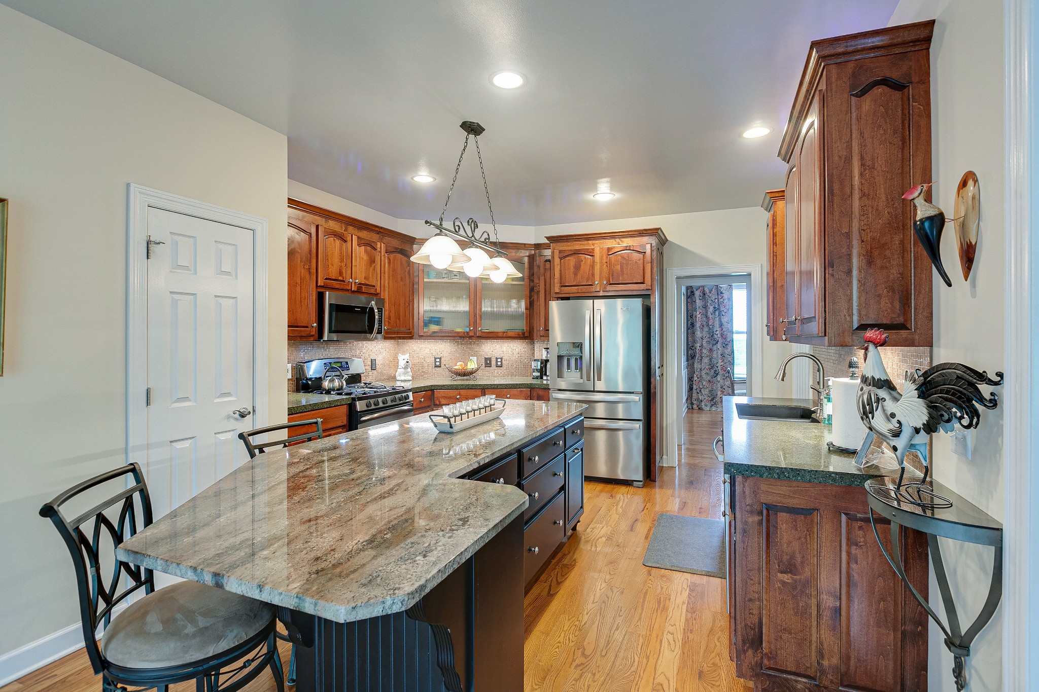 3013 Viewpointe Way Columbia, TN 38401 - Photo 17 of 39 a kitchen with stainless steel appliances granite countertop sink stove refrigerator dining table and chairs