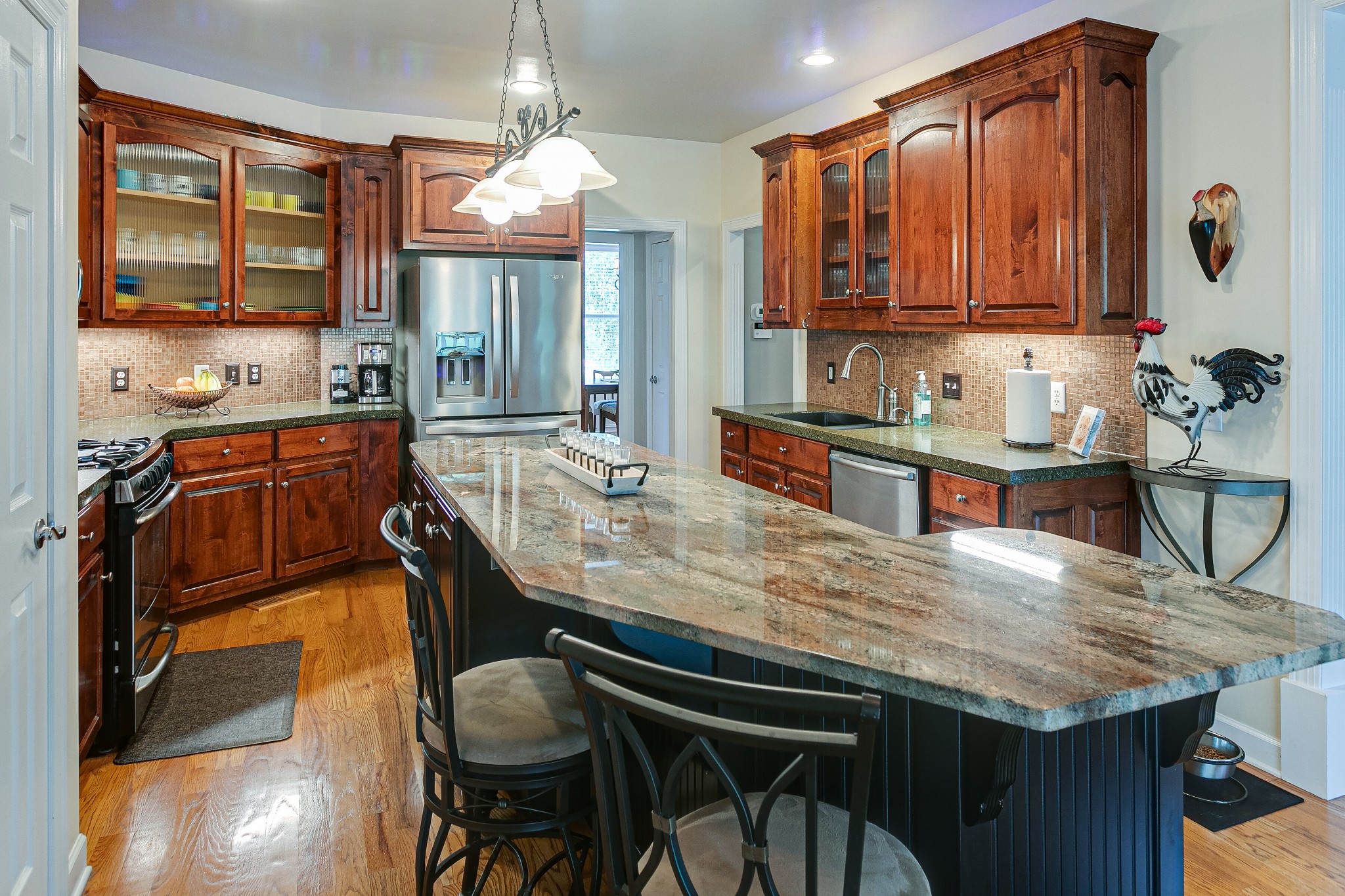 3013 Viewpointe Way Columbia, TN 38401 - Photo 18 of 39 a kitchen with granite countertop kitchen island stainless steel appliances a sink stove and wooden cabinets