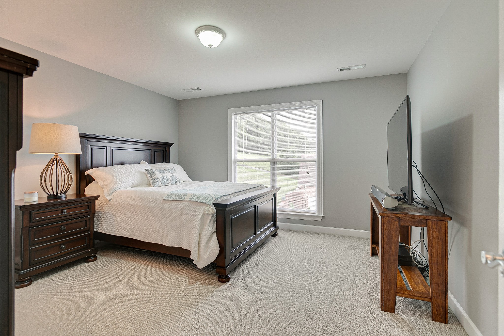 3013 Viewpointe Way Columbia, TN 38401 - Photo 28 of 39 a bedroom with a bed and a flat tv screen on the dresser