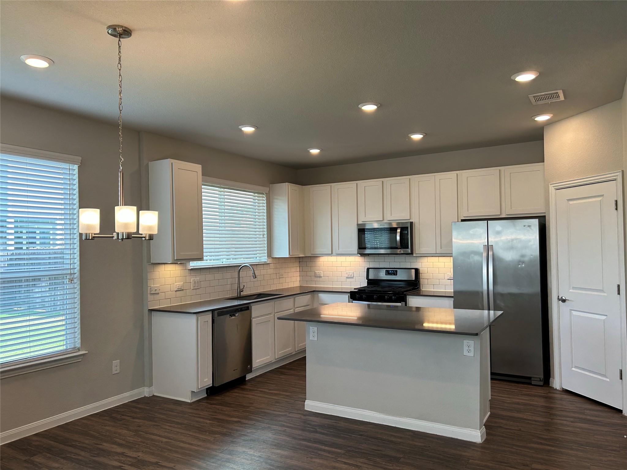 424 San Gabriel River Road Georgetown, TX 78626 - Photo 4 of 8 Modern kitchen with sleek stainless steel appliances and an inviting island, perfect for entertaining.