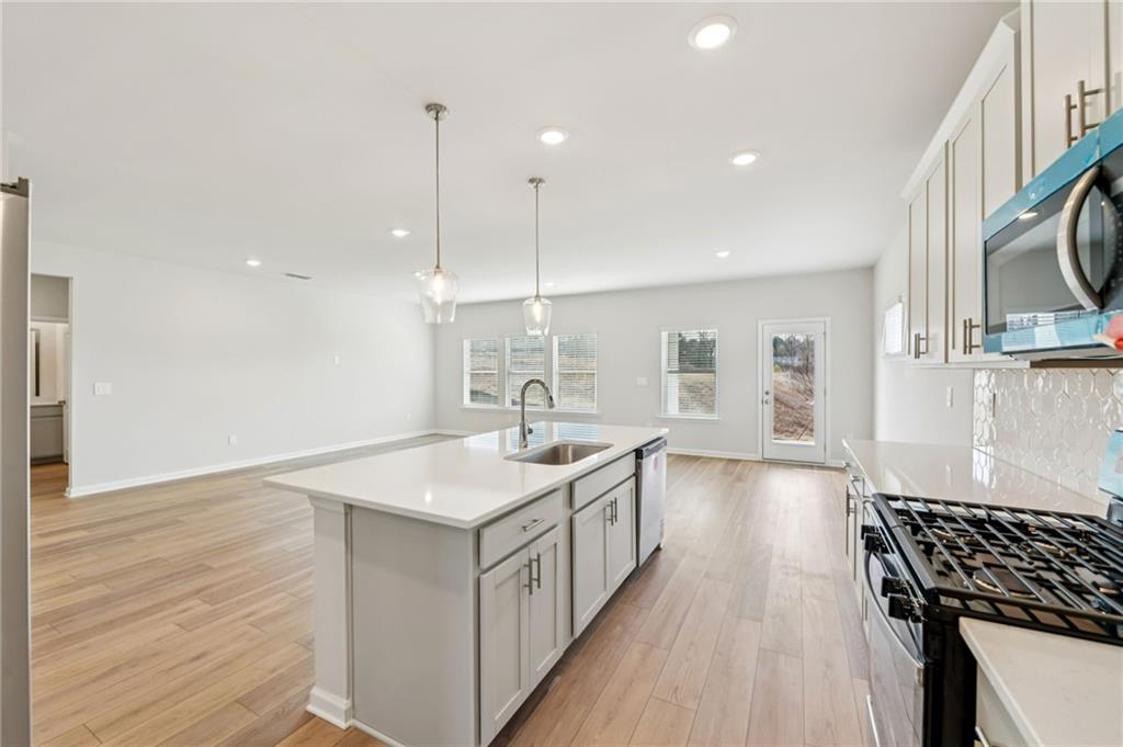 405 Morgan Crk Road Pendergrass, GA 30567 - Photo 15 of 48 a kitchen with a sink stove and wooden floor