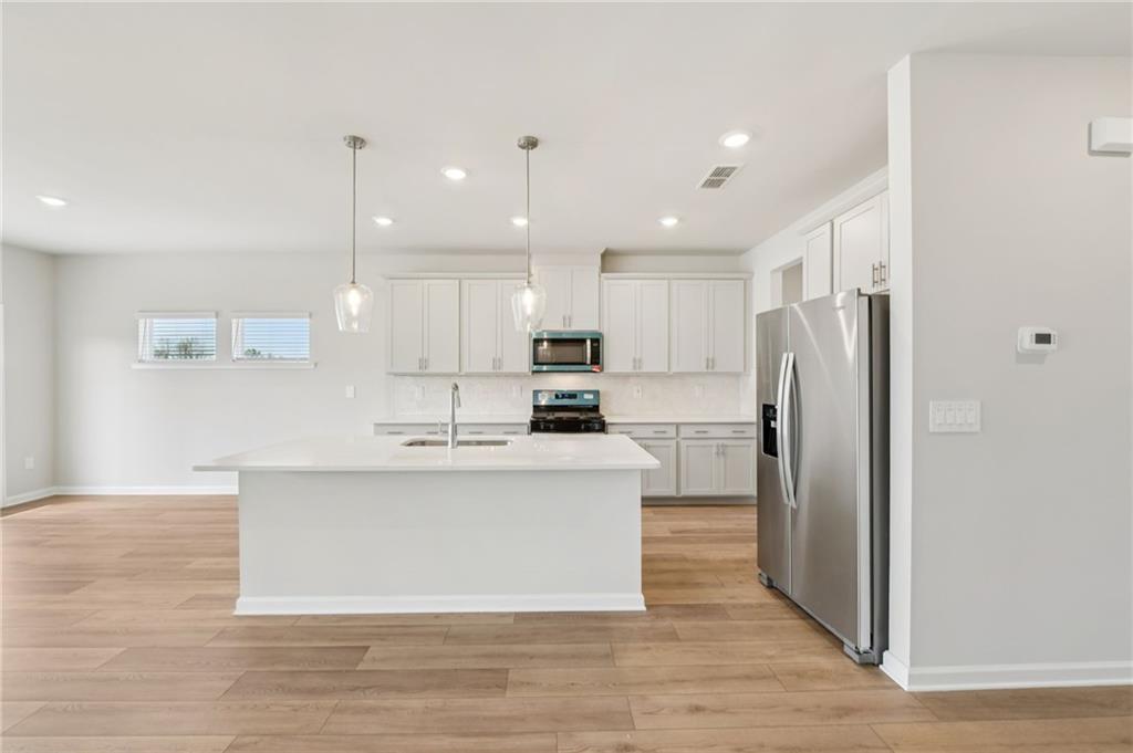 405 Morgan Crk Road Pendergrass, GA 30567 - Photo 17 of 48 a large kitchen with stainless steel appliances kitchen island a stove a refrigerator a sink and a oven