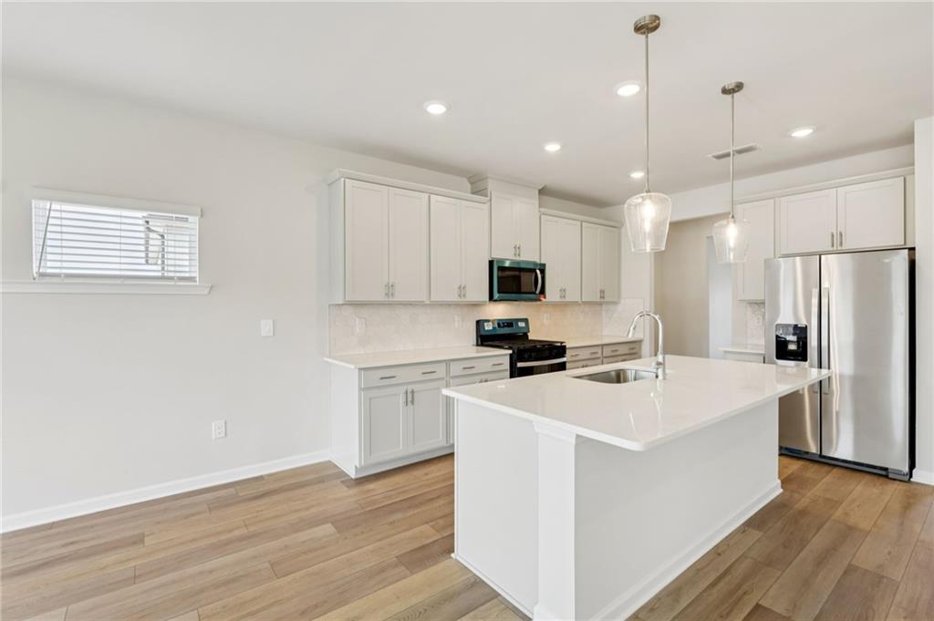 405 Morgan Crk Road Pendergrass, GA 30567 - Photo 18 of 48 a kitchen with a sink a refrigerator and a stove top oven
