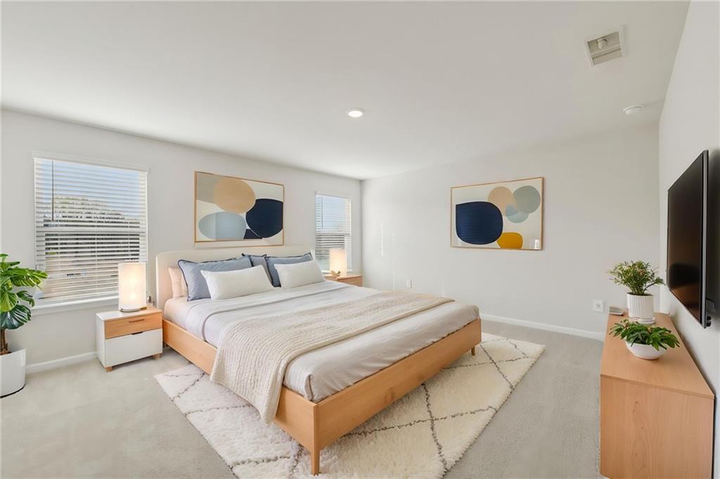 405 Morgan Crk Road Pendergrass, GA 30567 - Photo 30 of 48 a bedroom with a bed and a flat screen tv