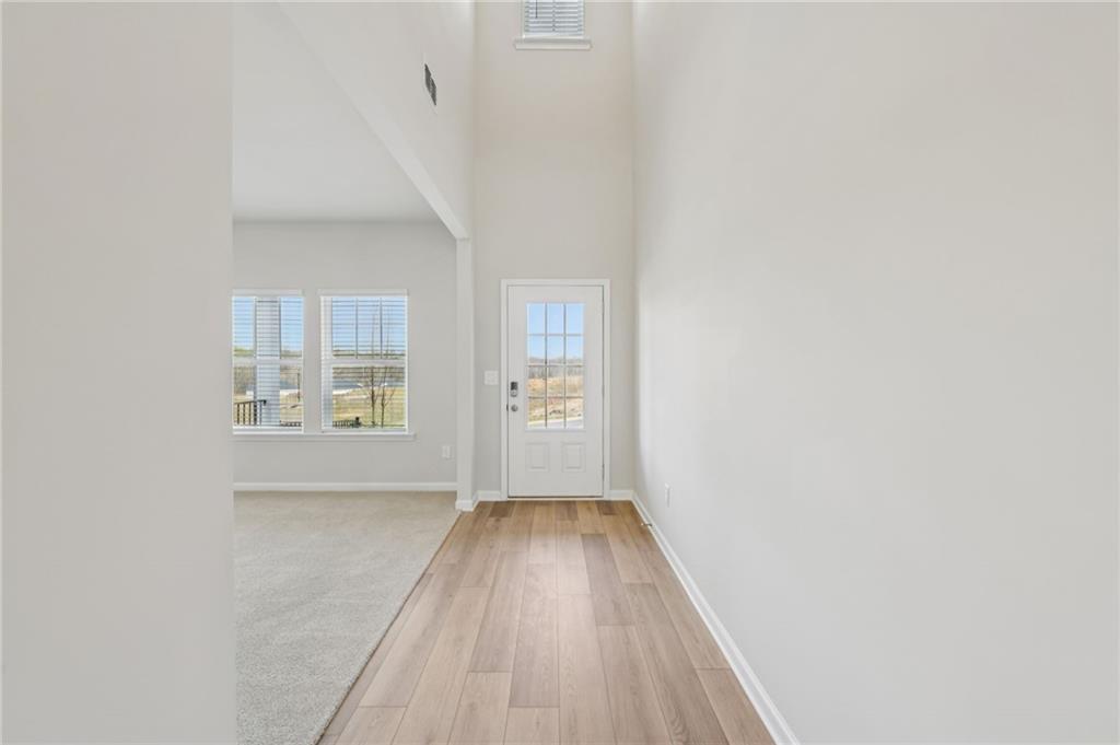 405 Morgan Crk Road Pendergrass, GA 30567 - Photo 3 of 48 a view of an empty room with wooden floor and a window