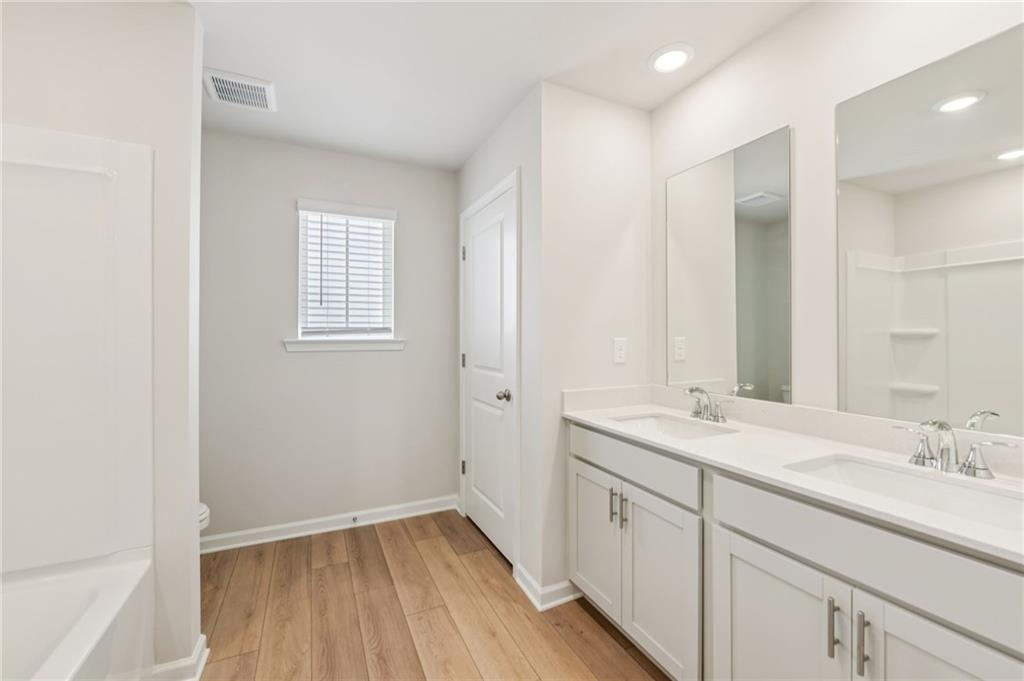 405 Morgan Crk Road Pendergrass, GA 30567 - Photo 36 of 48 a bathroom with a sink a mirror and a shower
