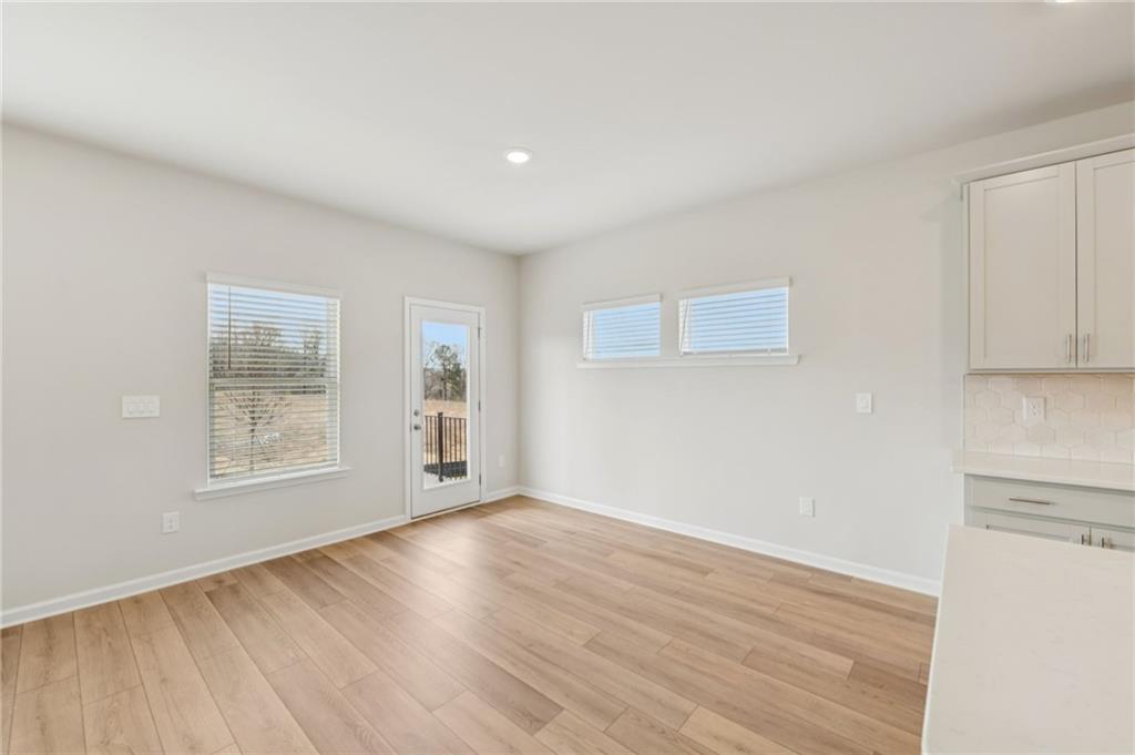 405 Morgan Crk Road Pendergrass, GA 30567 - Photo 10 of 48 a view of an empty room with wooden floor and a window