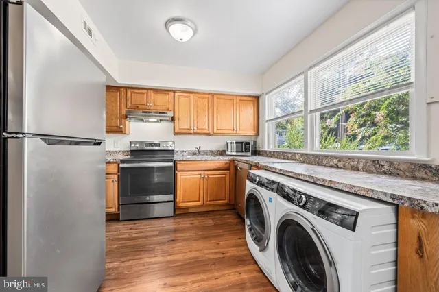 a kitchen with a refrigerator and window
