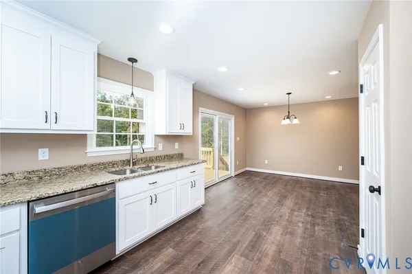 a kitchen with granite countertop a sink and a stove top oven