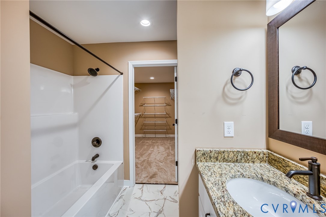 1900 Moody Fox Lane Carson, VA 23830 - Photo 18 of 38 a bathroom with a granite countertop sink a toilet and shower