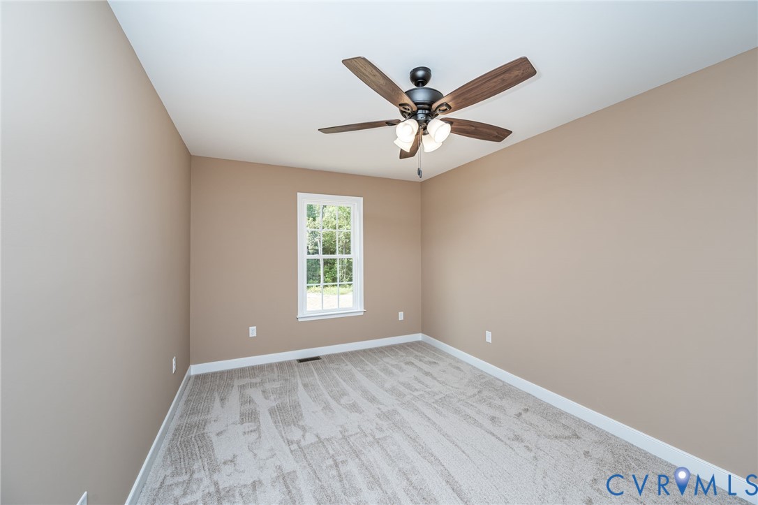 1900 Moody Fox Lane Carson, VA 23830 - Photo 22 of 38 a view of a big room with wooden floor closet and windows