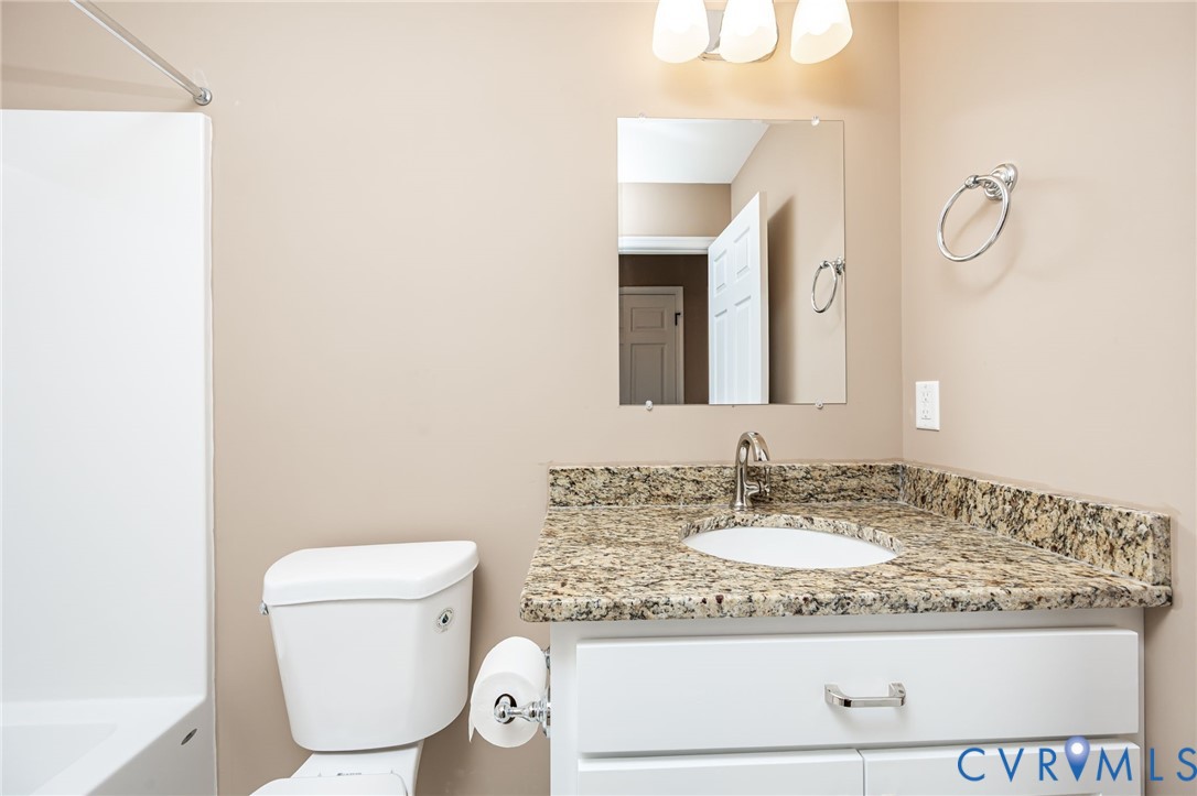 1900 Moody Fox Lane Carson, VA 23830 - Photo 24 of 38 a bathroom with a granite countertop sink and a mirror