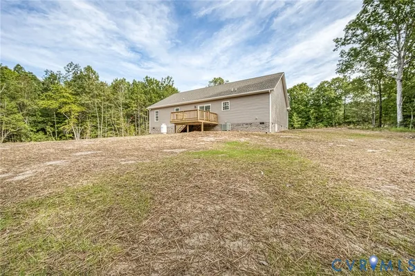 a house with yard and trees in front of it