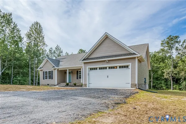 a view of a house with a yard and garage