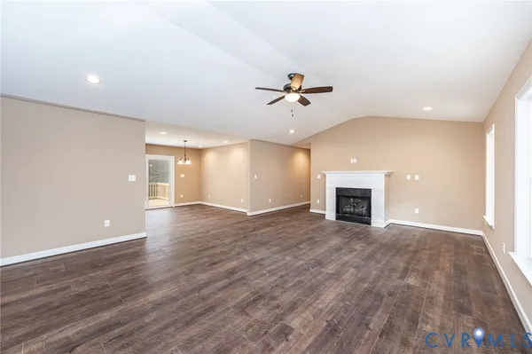 a view of an empty room with a fireplace and a window
