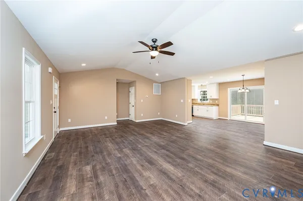 a view of a big room with wooden floor and a ceiling fan