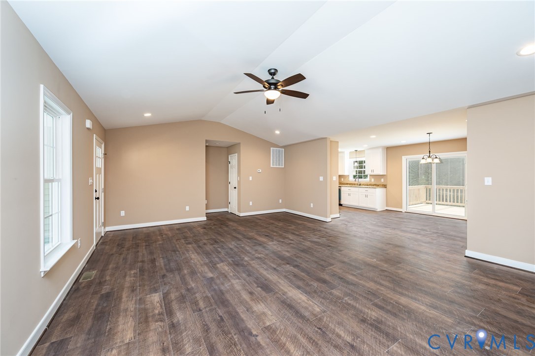 1900 Moody Fox Lane Carson, VA 23830 - Photo 9 of 38 a view of a big room with wooden floor and a ceiling fan