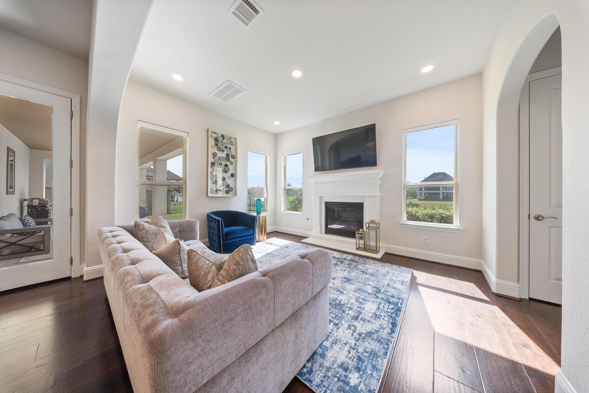 5403 Rouchel Brook Lane Sugar Land, TX 77479 - Photo 13 of 42 Hearth room just off the breakfast area, offering serene outdoor views and a versatile space to unwind or entertain. Thoughtfully designed for effortless gatherings with family and friends.