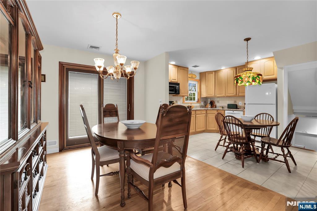 23 Ridge Court Cedar Grove, NJ 07009 - Photo 8 of 37 a view of a dining room with furniture and chandelier