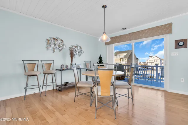 a large kitchen with kitchen island a large counter top space a sink stainless steel appliances and cabinets