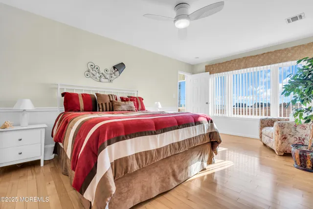 a spacious bathroom with a double vanity sink a mirror and a shower