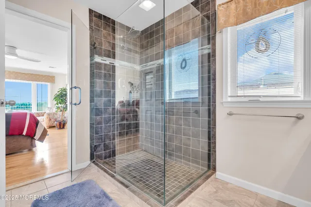 a bathroom with a granite countertop sink a toilet and mirror