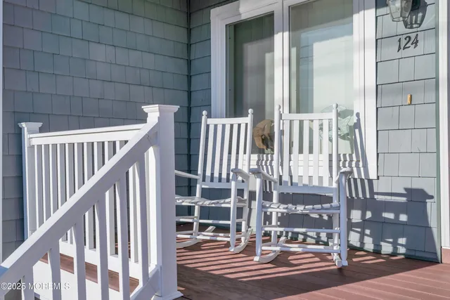 a view of staircase with lots of frames on wall and a large window
