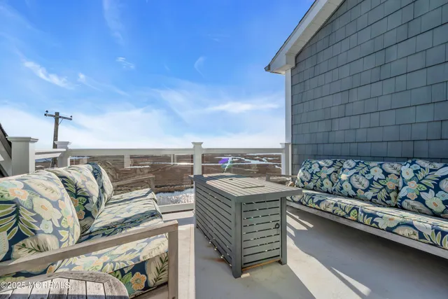 an aerial view of residential houses with outdoor space and ocean view