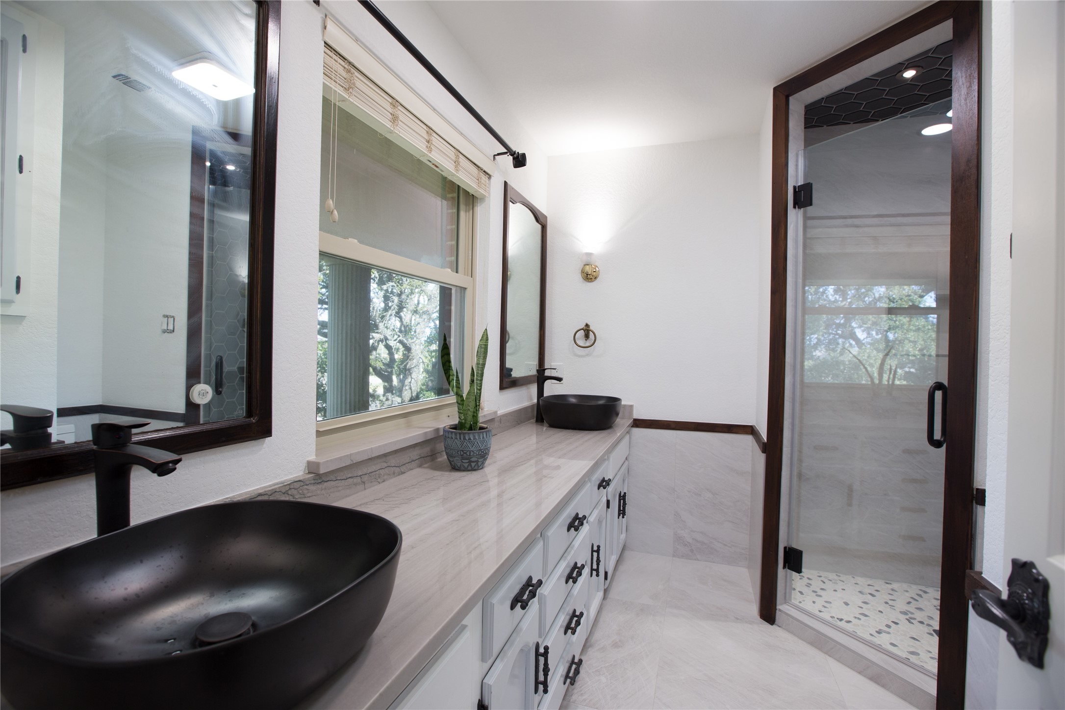 3517 Gattis School Road Round Rock, TX 78664 - Photo 13 of 16 Dual vessel sinks and elegant vanity provide ample storage in this refined bathroom.