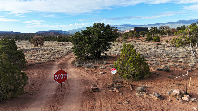 358 South Sky Drive Torrey, UT 84775 - Photo 55 of 82 Expansive desert landscape featuring a winding dirt road and distant mountain ranges