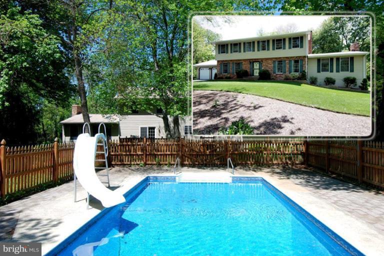 a view of a house with swimming pool and sitting area
