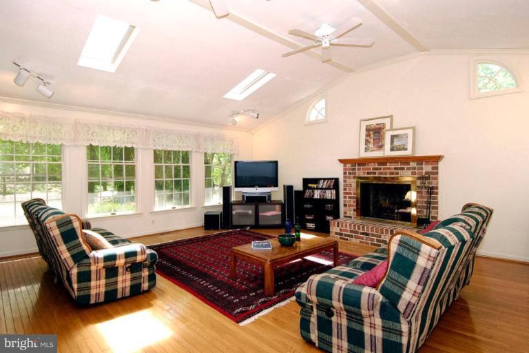 1907 Ridgewood Road Hanover, MD 21076 - Photo 15 of 30 a living room with furniture a flat screen tv and a fireplace