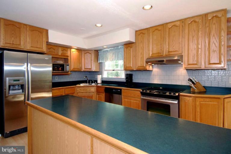 1907 Ridgewood Road Hanover, MD 21076 - Photo 16 of 30 a kitchen with stainless steel appliances granite countertop a stove a sink dishwasher a refrigerator and a microwave