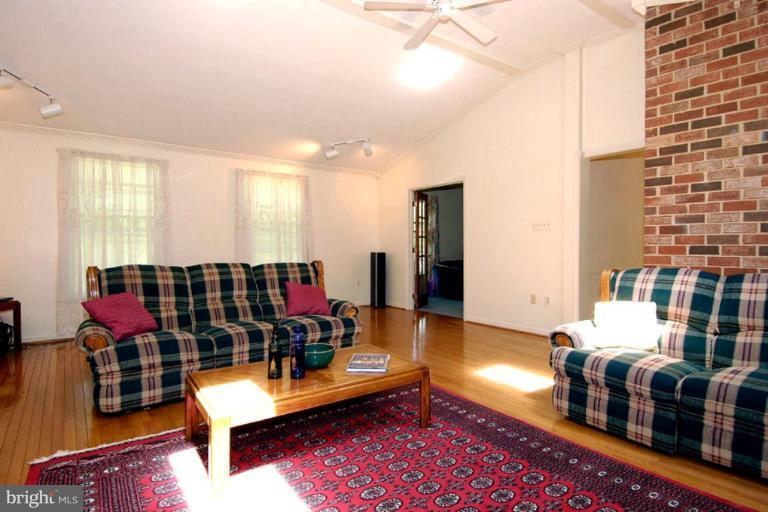 1907 Ridgewood Road Hanover, MD 21076 - Photo 25 of 30 a living room with furniture a rug and a chandelier