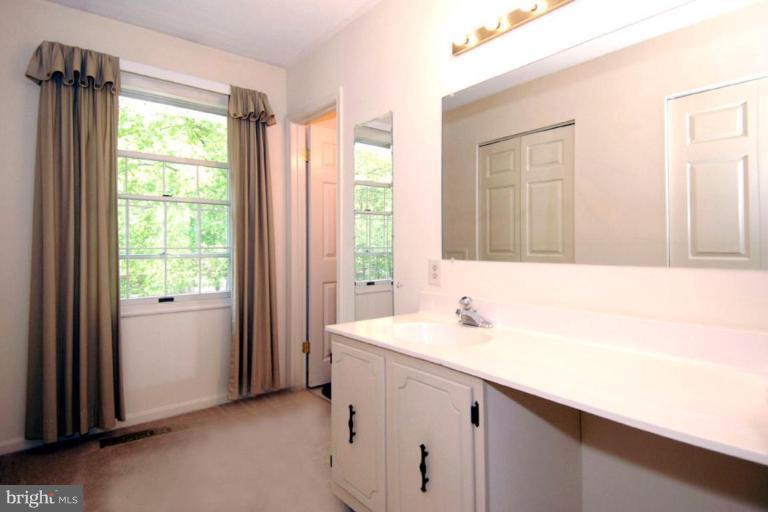 1907 Ridgewood Road Hanover, MD 21076 - Photo 29 of 30 a bathroom with a sink a mirror and a window
