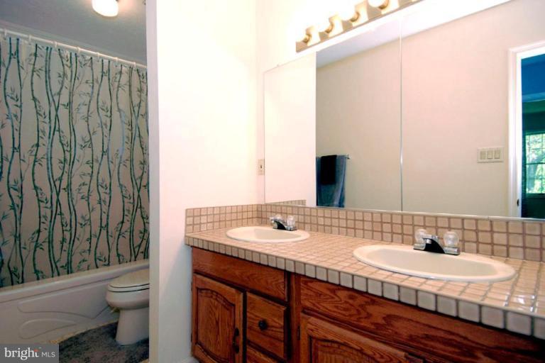1907 Ridgewood Road Hanover, MD 21076 - Photo 30 of 30 a bathroom with a granite countertop sink and a mirror