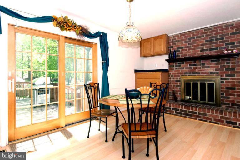 1907 Ridgewood Road Hanover, MD 21076 - Photo 9 of 30 a dining room with furniture a fireplace and wooden floor