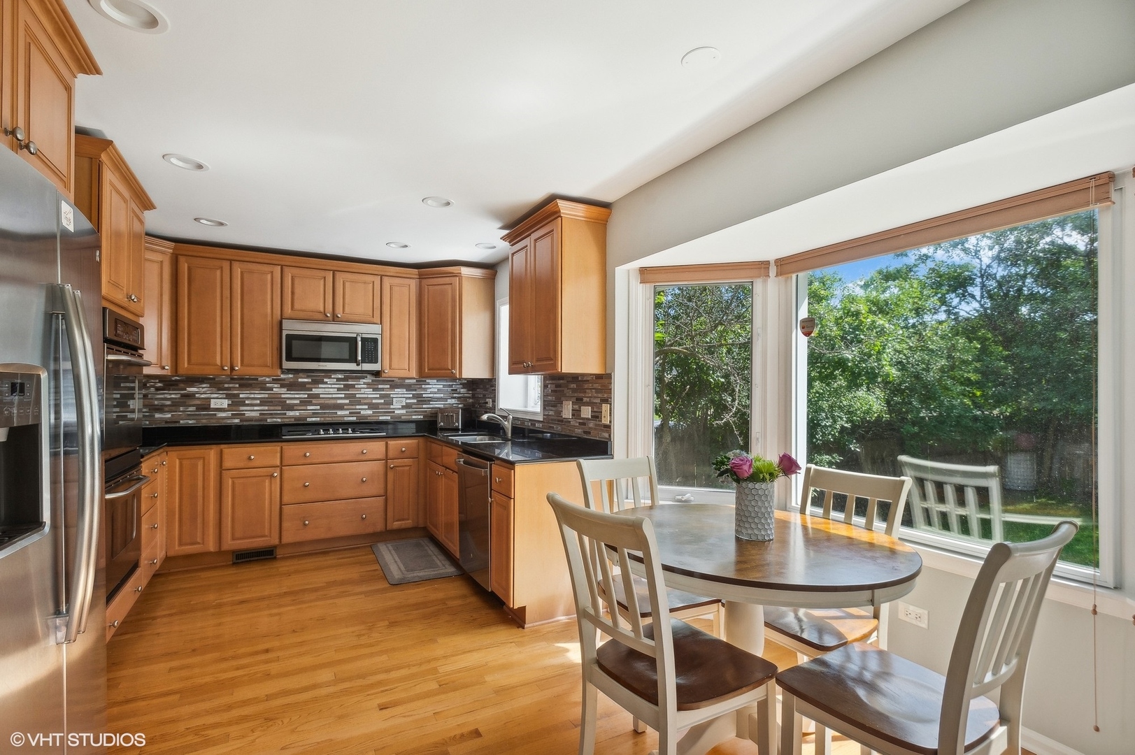 3951 Rutgers Lane Northbrook, IL 60062 - Photo 8 of 22 a kitchen with stainless steel appliances granite countertop a stove a kitchen island a table and chairs