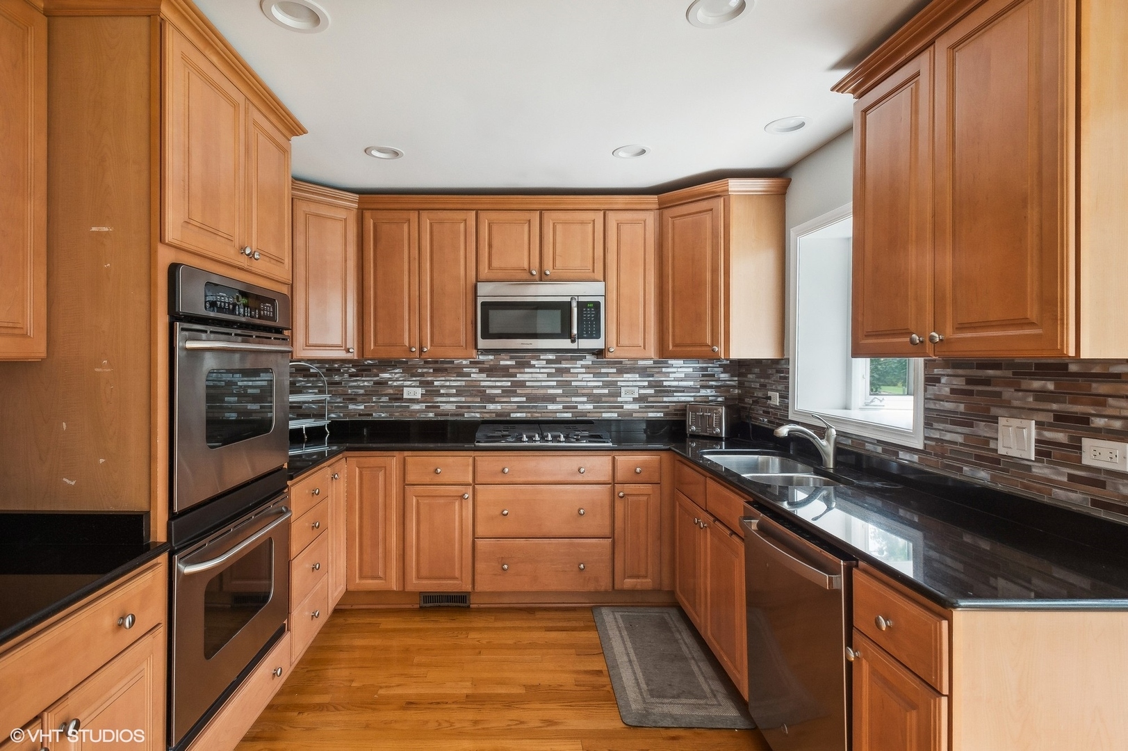 3951 Rutgers Lane Northbrook, IL 60062 - Photo 9 of 22 a kitchen with stainless steel appliances granite countertop a sink stove and microwave