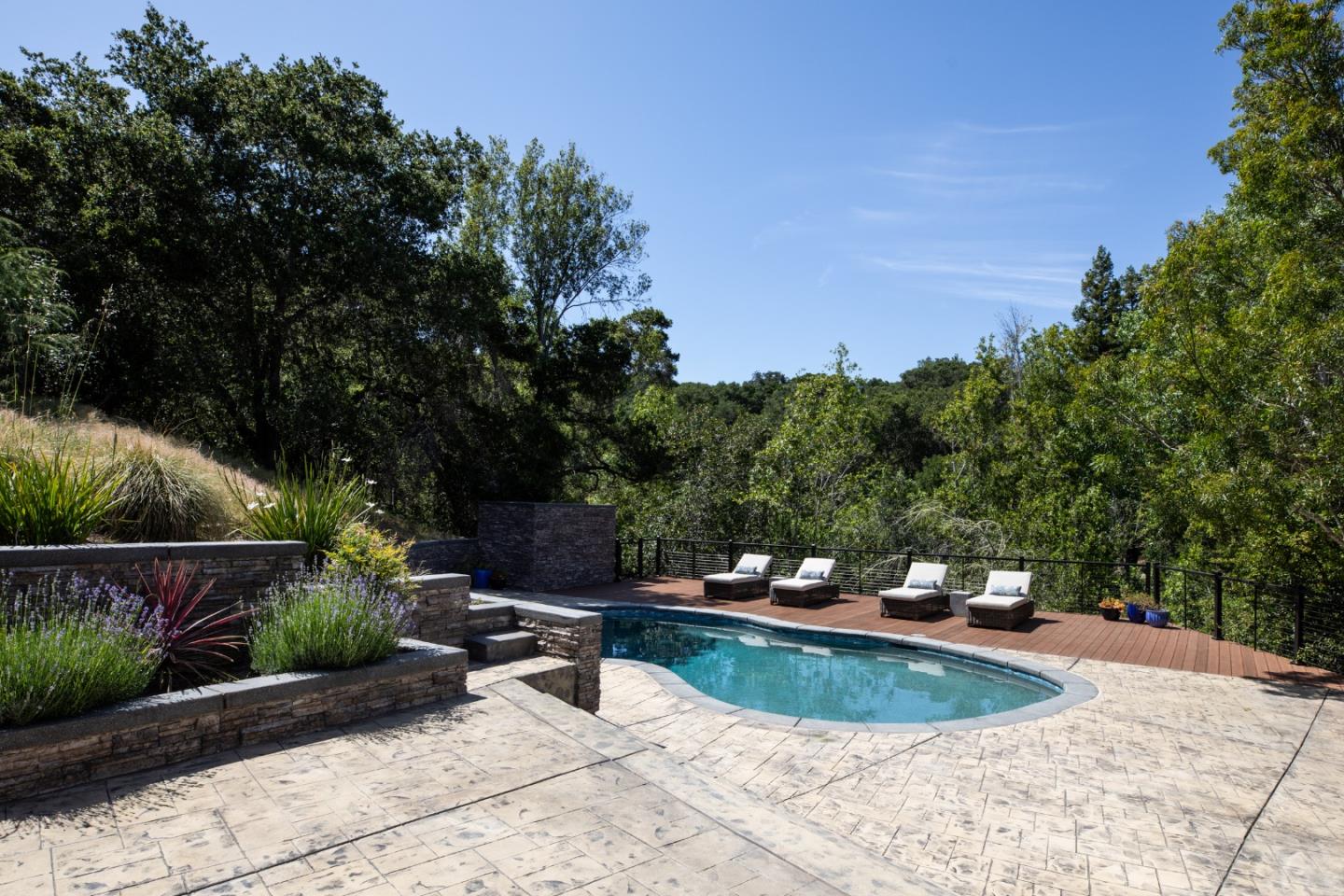 345 Harcross Road Woodside, CA 94062 - Photo 28 of 37 a view of a swimming pool with a patio and plants