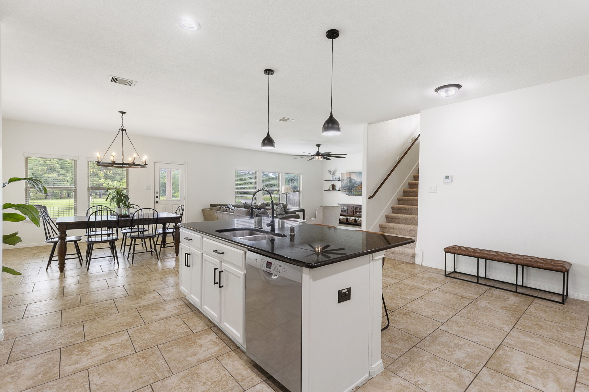 22810 Dale River Road Tomball, TX 77375 - Photo 11 of 44 Updated lighting, neutral paint and oversized tile highlight this downstairs living area.