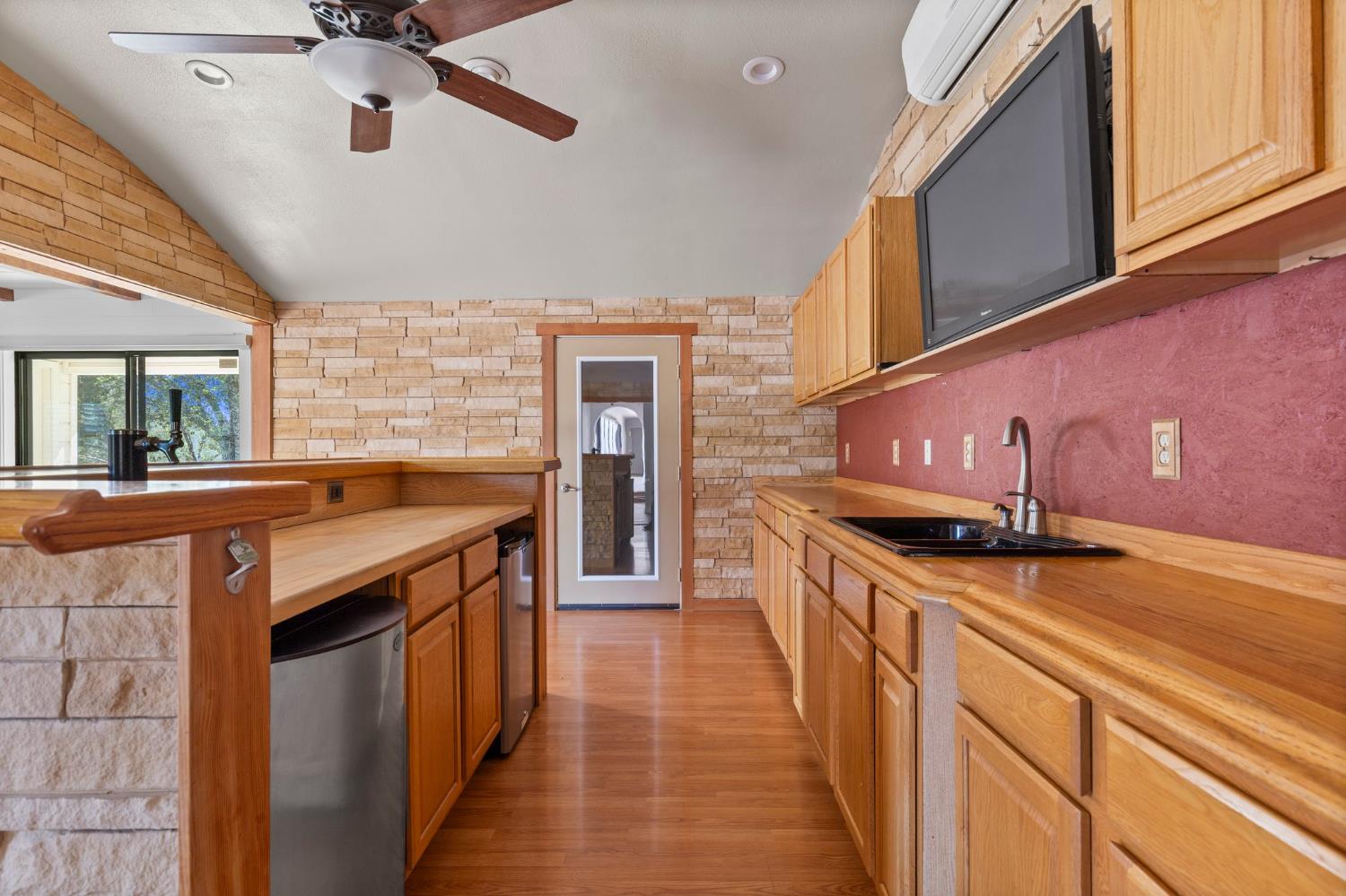 20160 Latrobe Road Plymouth, CA 95669 - Photo 12 of 37 a kitchen with stainless steel appliances granite countertop a sink a stove and a wooden floors