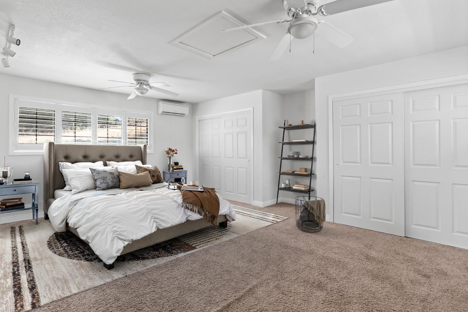 20160 Latrobe Road Plymouth, CA 95669 - Photo 15 of 37 a bedroom with a bed and a chandelier