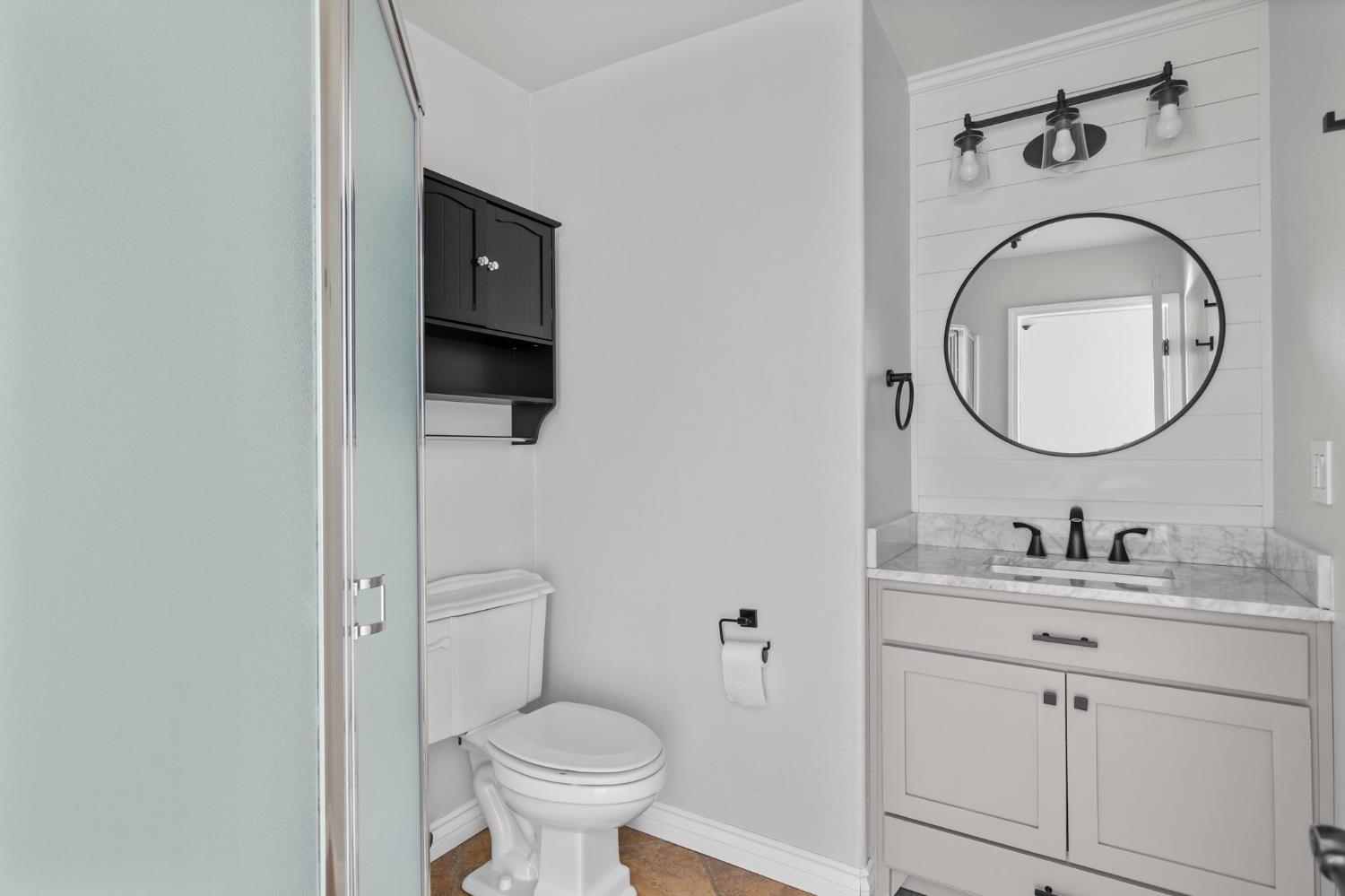 20160 Latrobe Road Plymouth, CA 95669 - Photo 16 of 37 a bathroom with a toilet a sink and mirror