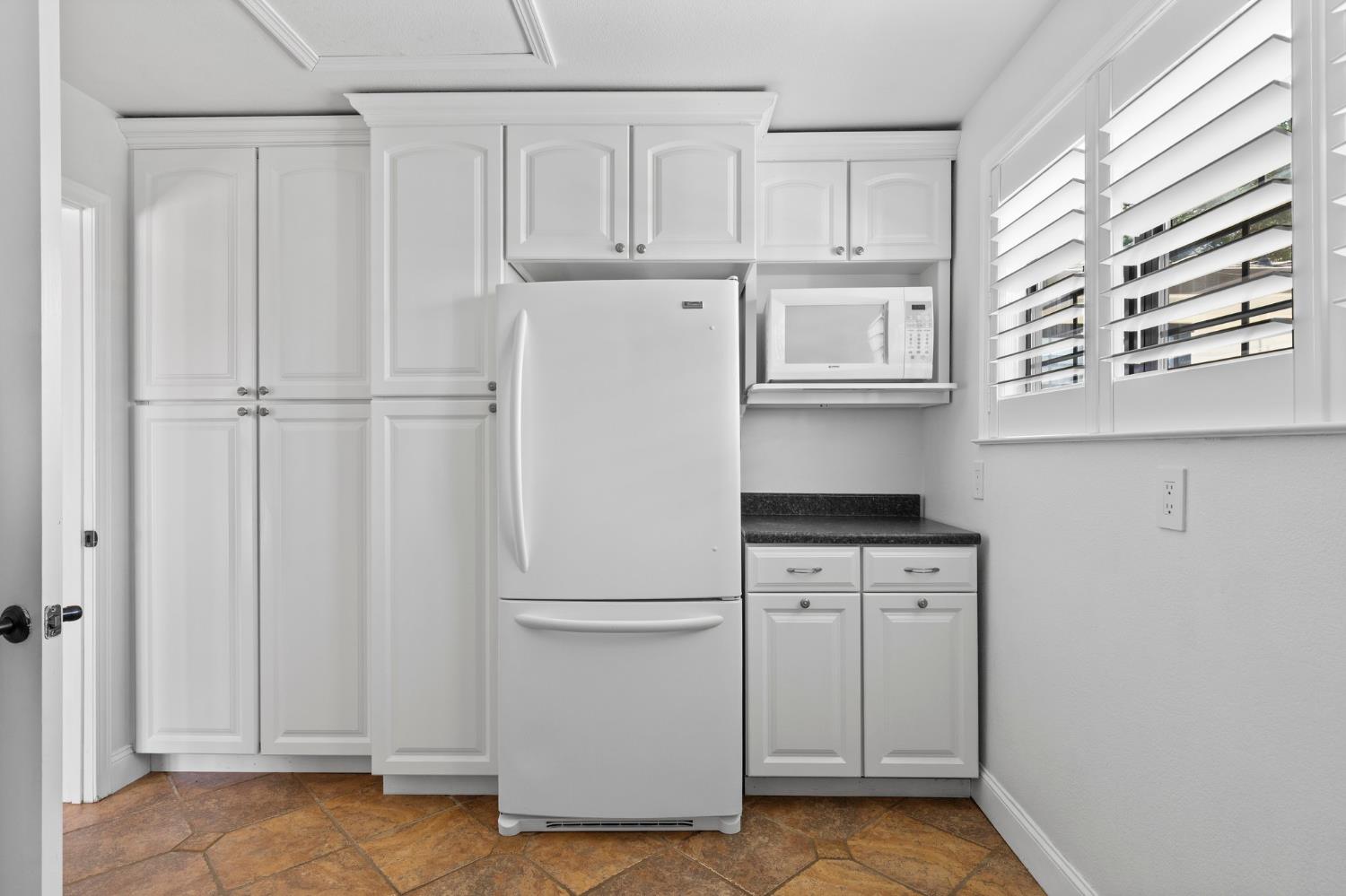 20160 Latrobe Road Plymouth, CA 95669 - Photo 17 of 37 a white refrigerator freezer and a stove sitting inside of a kitchen