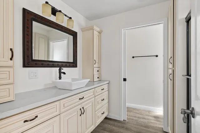 a bathroom with a double vanity sink mirror and shower