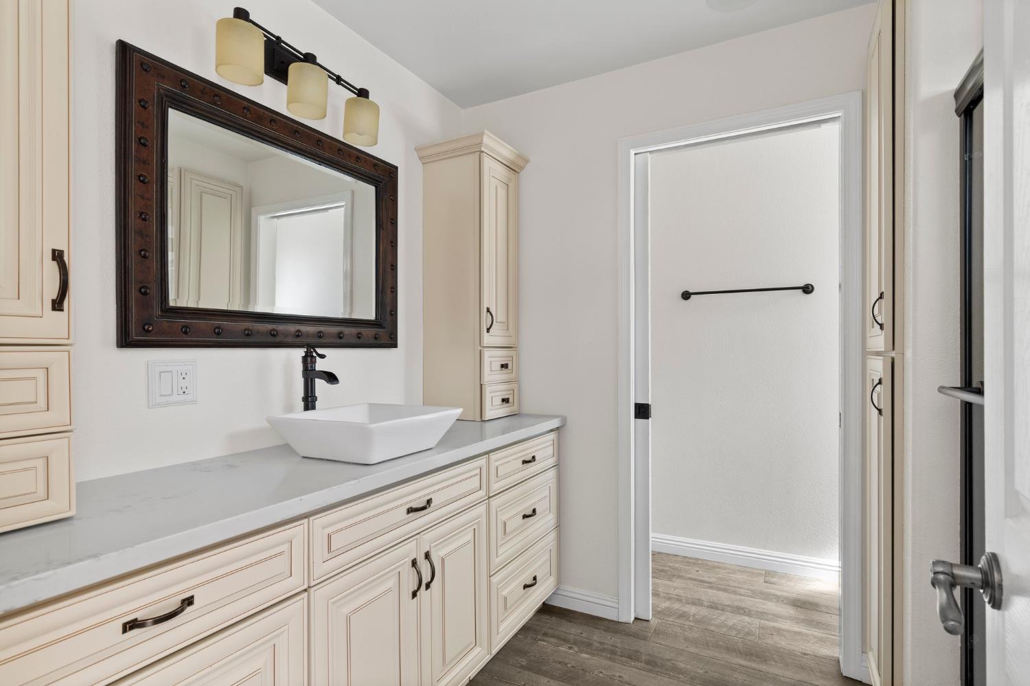 20160 Latrobe Road Plymouth, CA 95669 - Photo 22 of 37 a bathroom with a double vanity sink and mirror
