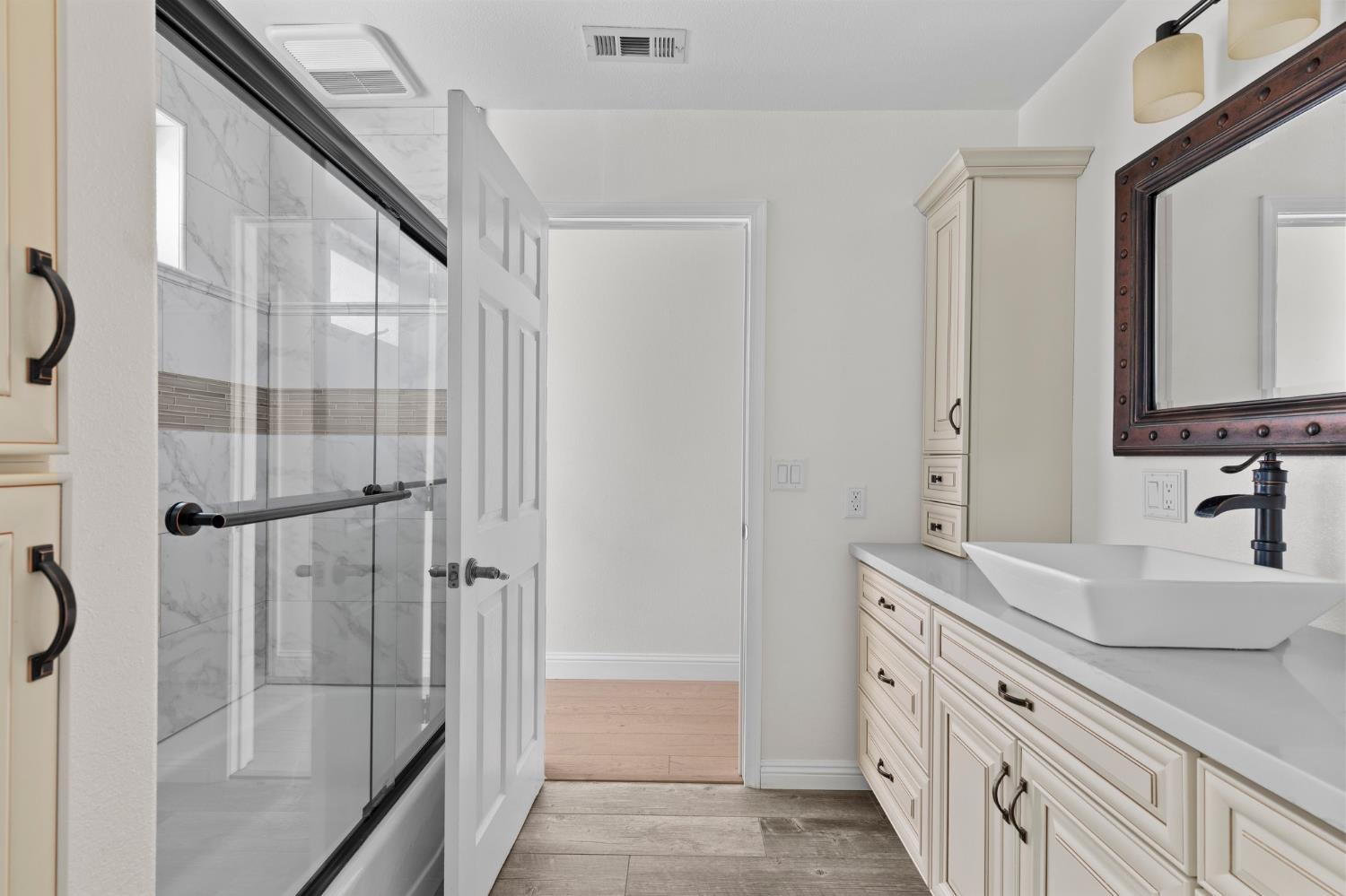 20160 Latrobe Road Plymouth, CA 95669 - Photo 24 of 37 a bathroom with a double vanity sink mirror and shower