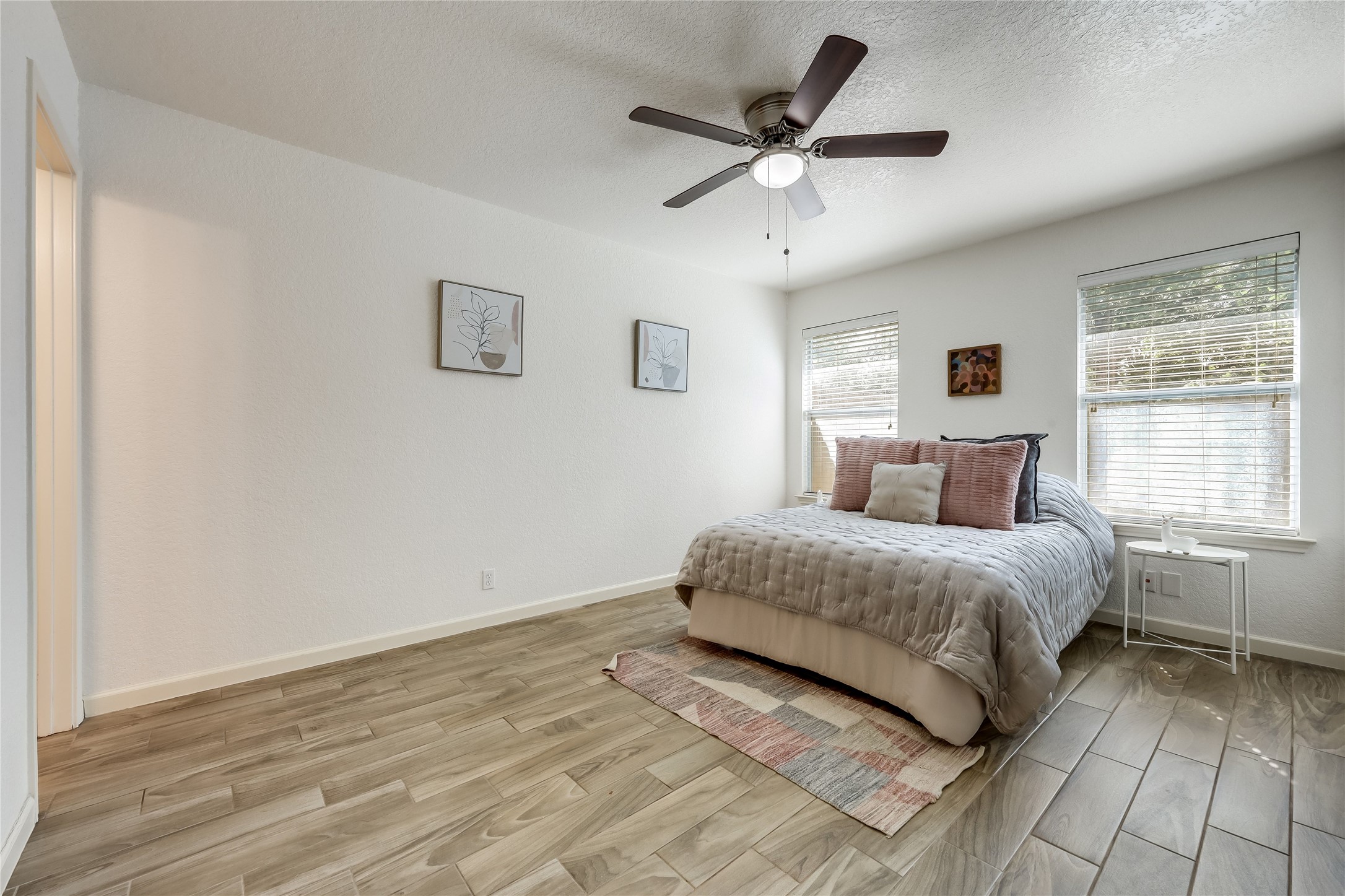 4510 Secure Lane Austin, TX 78725 - Photo 12 of 24 a spacious bedroom with a large bed and a chandelier