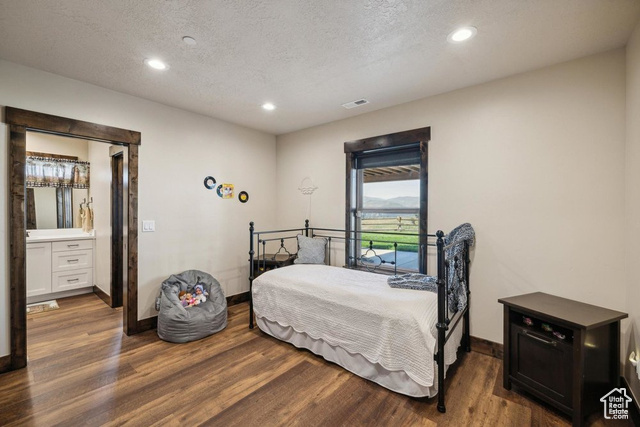 6117 North Rocky Ridge Road Peoa, UT 84061 - Photo 63 of 83 Bedroom with dark hardwood / wood-style floors and a textured ceiling